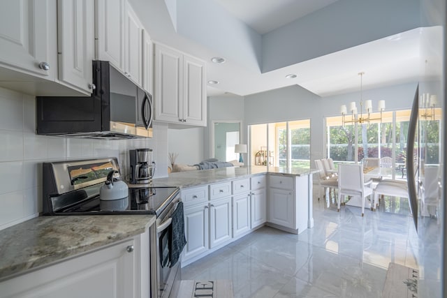 kitchen with electric range, a peninsula, and white cabinetry