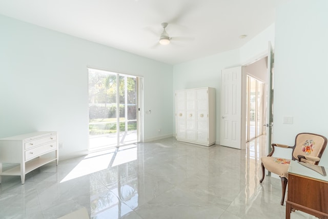 bedroom with baseboards, marble finish floor, ceiling fan, and access to exterior