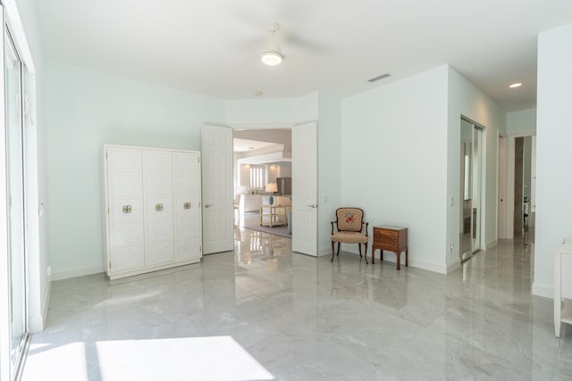 interior space with recessed lighting, baseboards, marble finish floor, and visible vents