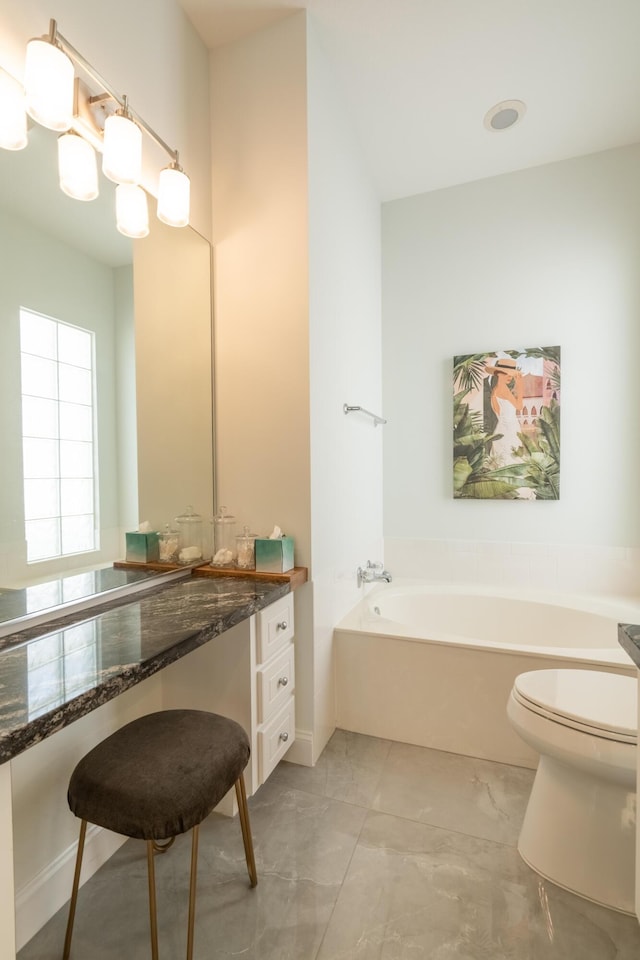 full bathroom featuring vanity, a garden tub, toilet, and marble finish floor