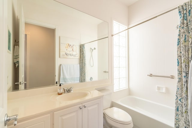 bathroom featuring vanity, shower / tub combo, and toilet