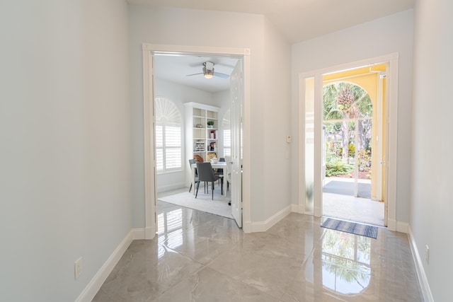 entrance foyer featuring plenty of natural light, baseboards, and ceiling fan