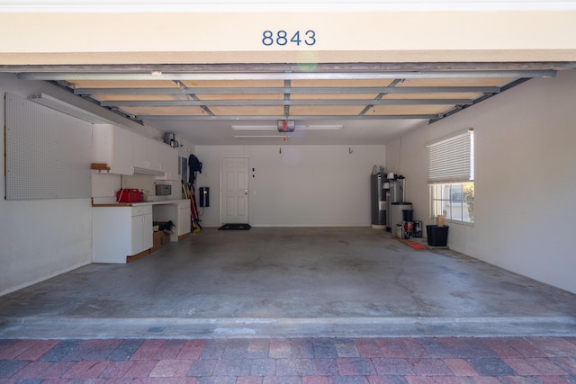 garage featuring a garage door opener and water heater