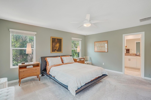 bedroom featuring a ceiling fan, baseboards, visible vents, and light carpet