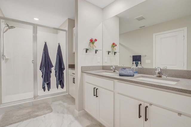 bathroom with a sink, a shower stall, and marble finish floor
