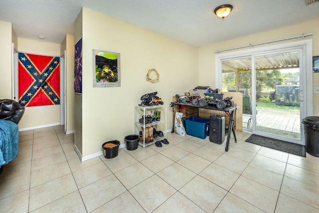interior space with baseboards and light tile patterned flooring