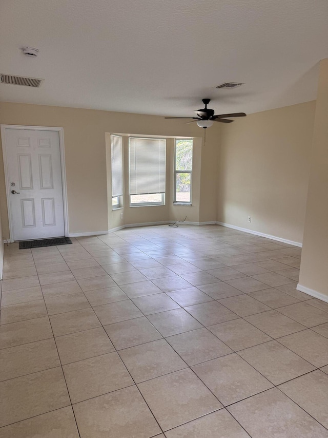 17924 W Sycamore Dr, Loxahatchee, FL 33470 - empty room with ceiling fan, baseboards, a smoke detector, and light tile patterned floors