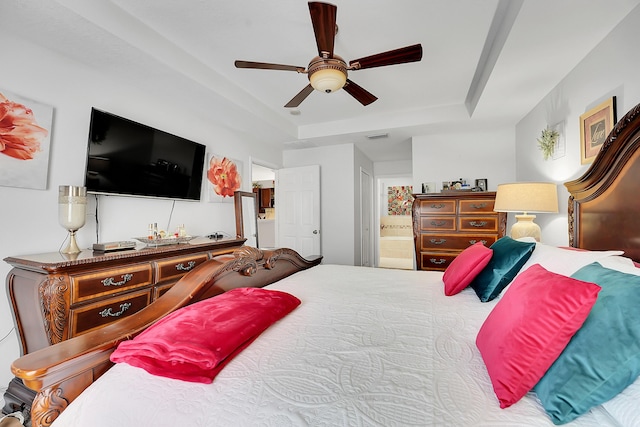 bedroom with a ceiling fan, visible vents, ensuite bathroom, and a raised ceiling