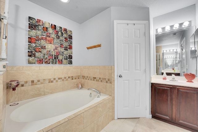 bathroom featuring visible vents, tile patterned flooring, a bath, and vanity