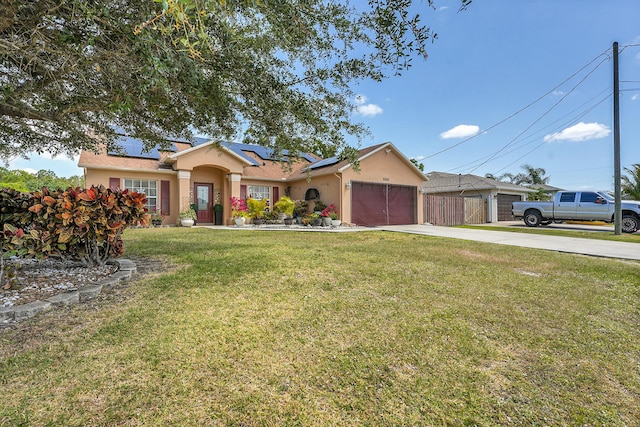ranch-style house featuring a front yard, a garage, roof mounted solar panels, concrete driveway, and stucco siding