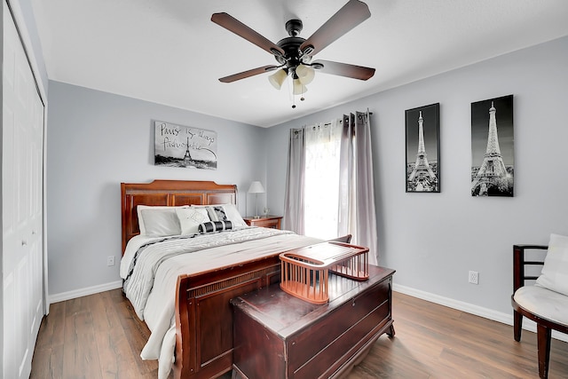 bedroom with baseboards, ceiling fan, and wood finished floors