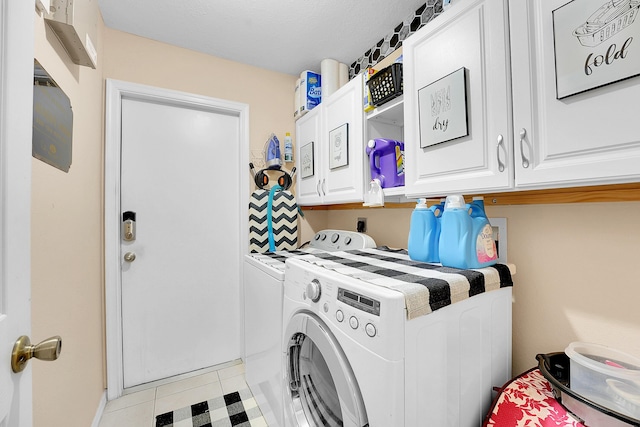 clothes washing area with baseboards, cabinet space, and washer and dryer