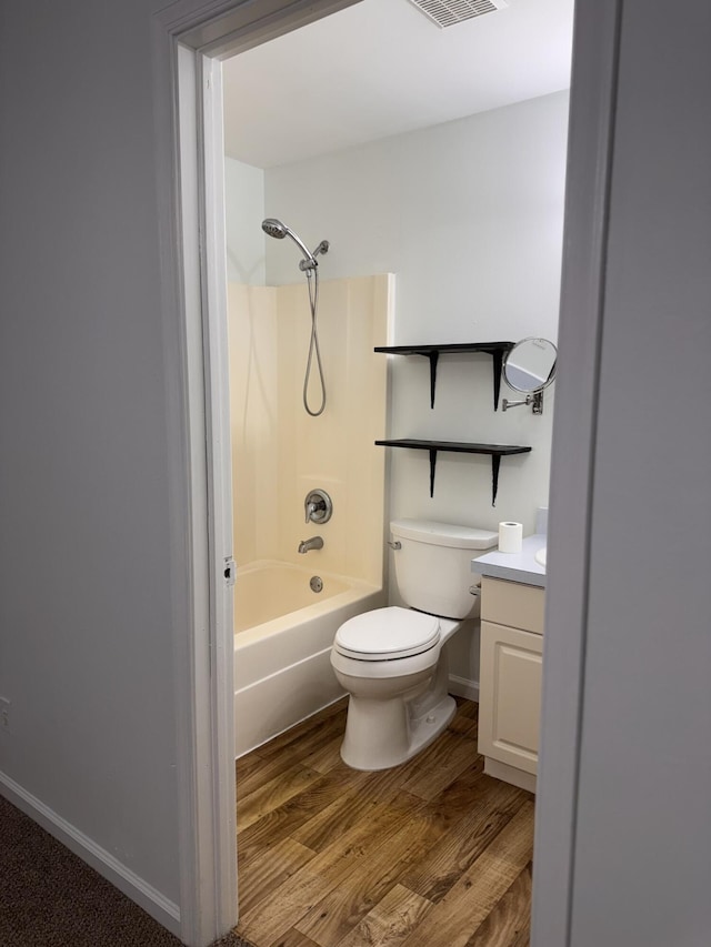 17917 49th St N, Loxahatchee, FL 33470 - bathroom featuring wood finished floors, vanity, toilet, bathtub / shower combination, and baseboards