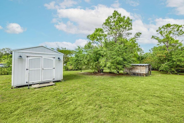 view of yard featuring a storage unit and an outbuilding