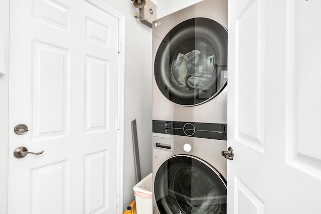 21256 Via Fiore, Boca Raton, FL 33433 - clothes washing area featuring estacked washer and dryer