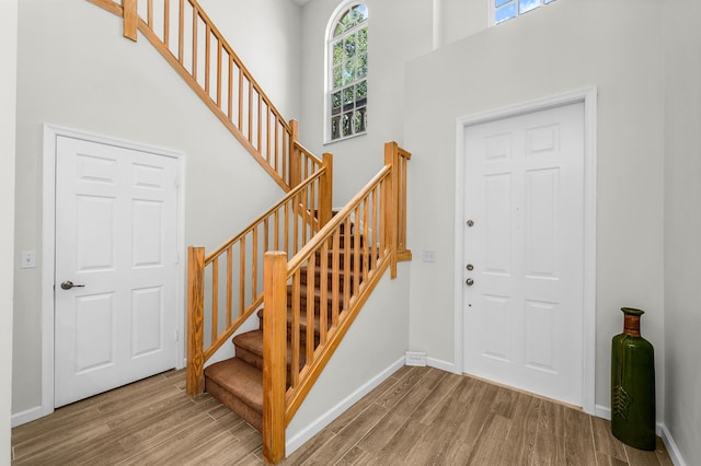21256 Via Fiore, Boca Raton, FL 33433 - foyer with wood finished floors, a towering ceiling, stairs, and baseboards