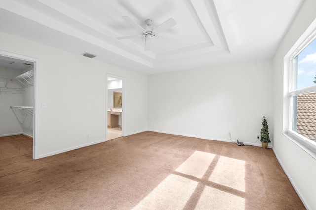 21256 Via Fiore, Boca Raton, FL 33433 - unfurnished bedroom with a raised ceiling, light colored carpet, a walk in closet, a ceiling fan, and ensuite bathroom