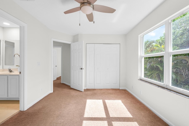 21256 Via Fiore, Boca Raton, FL 33433 - unfurnished bedroom featuring multiple windows, light colored carpet, and ensuite bathroom