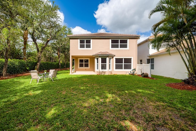 21256 Via Fiore, Boca Raton, FL 33433 - back of house with a tile roof, stucco siding, a lawn, and a patio area