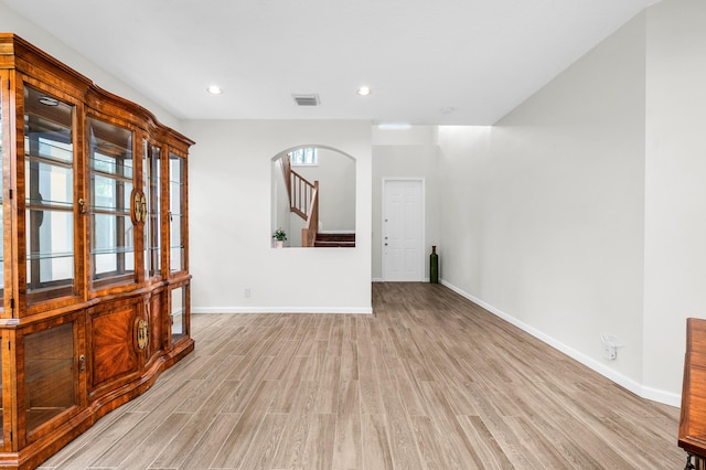 21256 Via Fiore, Boca Raton, FL 33433 - unfurnished room with light wood-style flooring, baseboards, stairs, recessed lighting, and arched walkways