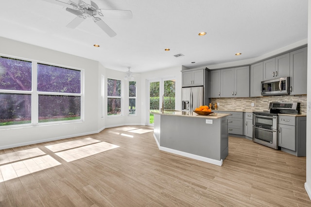 21256 Via Fiore, Boca Raton, FL 33433 - kitchen with appliances with stainless steel finishes, gray cabinetry, tasteful backsplash, light countertops, and recessed lighting