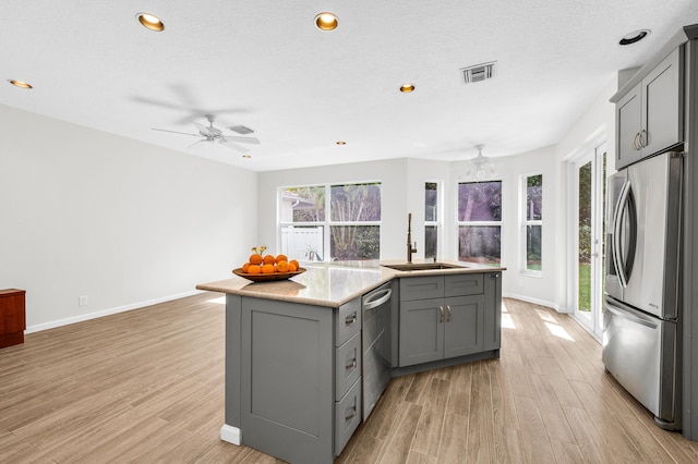 21256 Via Fiore, Boca Raton, FL 33433 - kitchen featuring stainless steel appliances, gray cabinets, a sink, light wood-style floors, and recessed lighting