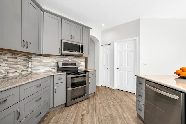 21256 Via Fiore, Boca Raton, FL 33433 - kitchen with stainless steel appliances, gray cabinets, light wood-type flooring, light countertops, and recessed lighting