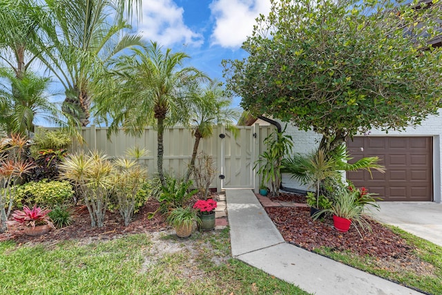 view of yard with fence, a gate, and driveway