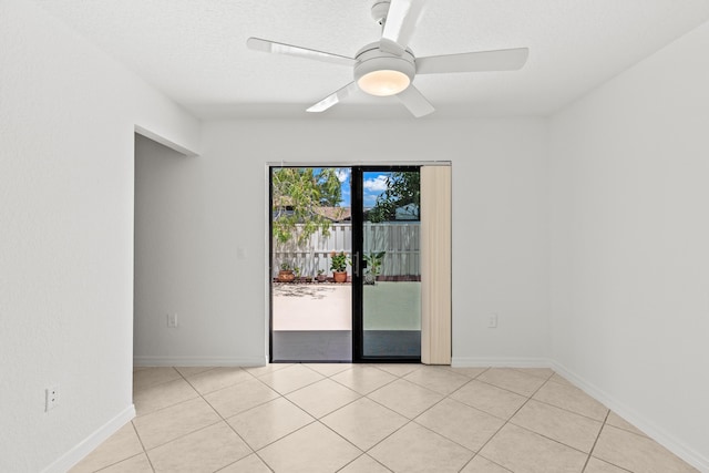 unfurnished room featuring baseboards, a ceiling fan, and light tile patterned flooring