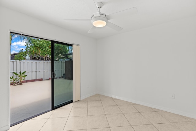 spare room featuring baseboards, a ceiling fan, and light tile patterned floors