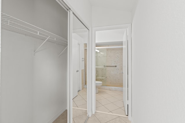 spacious closet with light tile patterned floors