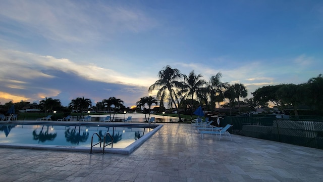 community pool featuring a patio and fence