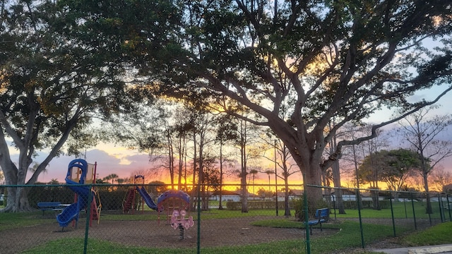 playground at dusk featuring fence and playground community