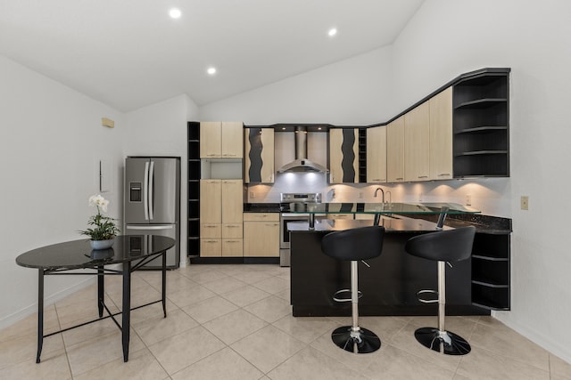kitchen with wall chimney range hood, dark countertops, open shelves, stainless steel appliances, and a peninsula