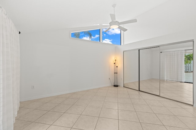 unfurnished bedroom featuring a closet, ceiling fan, and high vaulted ceiling