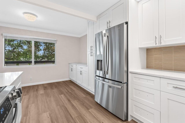 kitchen with stainless steel appliances, crown molding, light wood-type flooring, white cabinetry, and baseboards