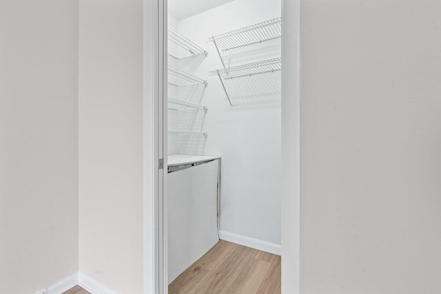 walk in closet featuring light wood-style floors