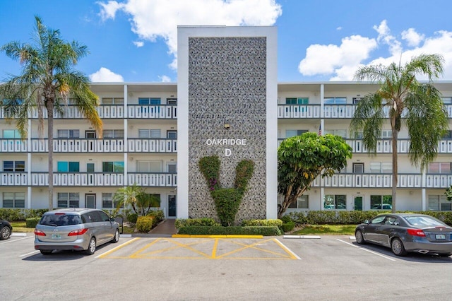 view of building exterior with uncovered parking
