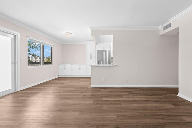 unfurnished living room with crown molding, baseboards, dark wood-style floors, and visible vents