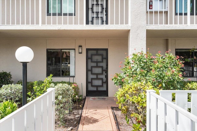 property entrance featuring stucco siding