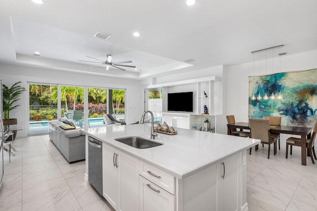 kitchen featuring a sink, dishwasher, marble finish floor, open floor plan, and visible vents