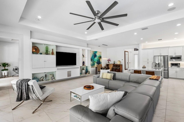 living area with recessed lighting, a ceiling fan, visible vents, and marble finish floor