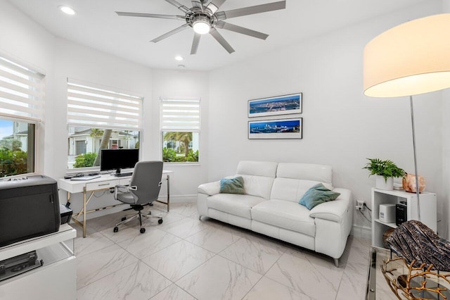 office featuring a healthy amount of sunlight, a ceiling fan, recessed lighting, and marble finish floor