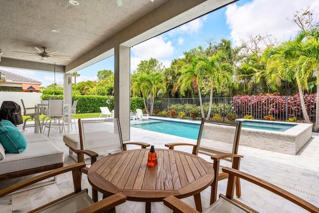 view of pool with a fenced backyard, a fenced in pool, outdoor dining area, a patio area, and a ceiling fan