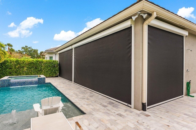 view of swimming pool featuring a patio and a pool with connected hot tub
