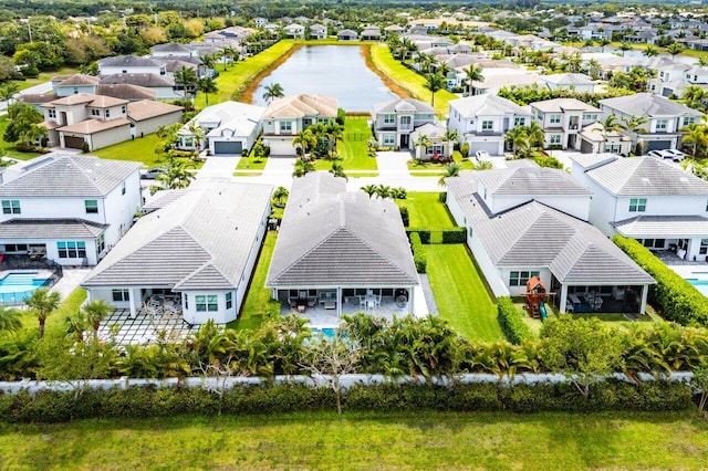 drone / aerial view with a water view and a residential view