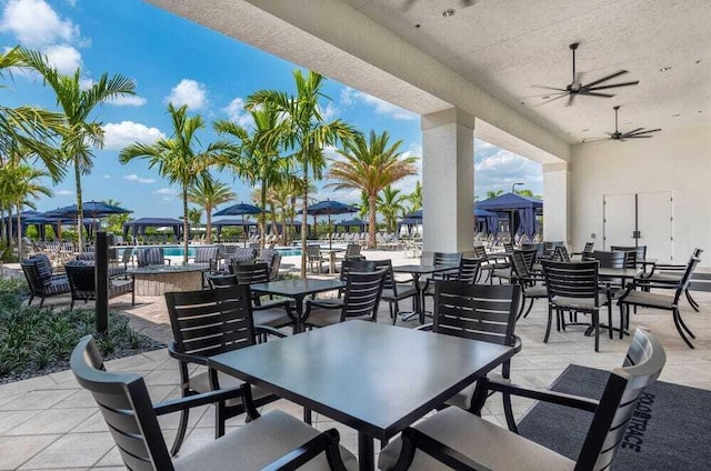 view of patio featuring a gazebo, outdoor dining area, and ceiling fan