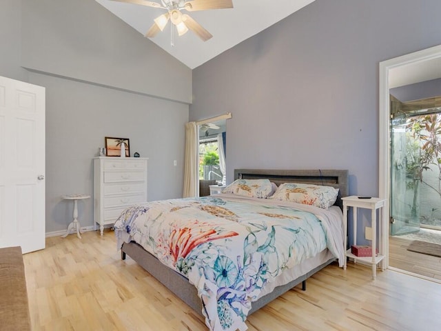 bedroom with ceiling fan, wood finished floors, high vaulted ceiling, baseboards, and connected bathroom