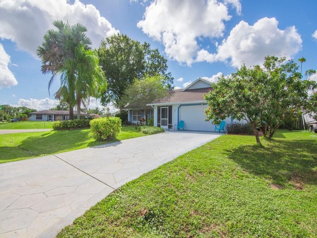 ranch-style house featuring an attached garage, driveway, and a front yard