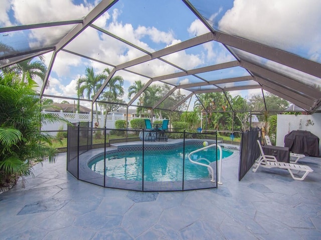 view of pool featuring a fenced in pool, a patio, and a grill